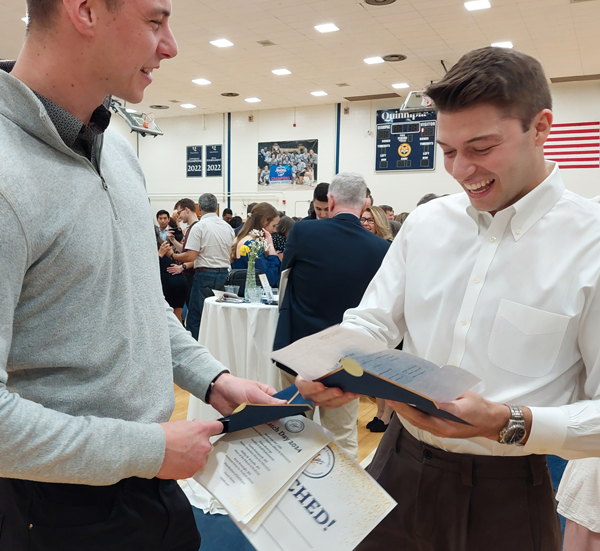Jonah Cremin-Endes opens his Match envelope and smiles broadly as his friend looks on