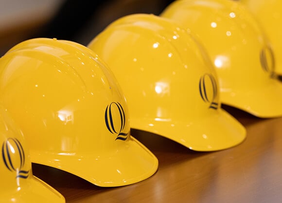 Gold hard hats in a row