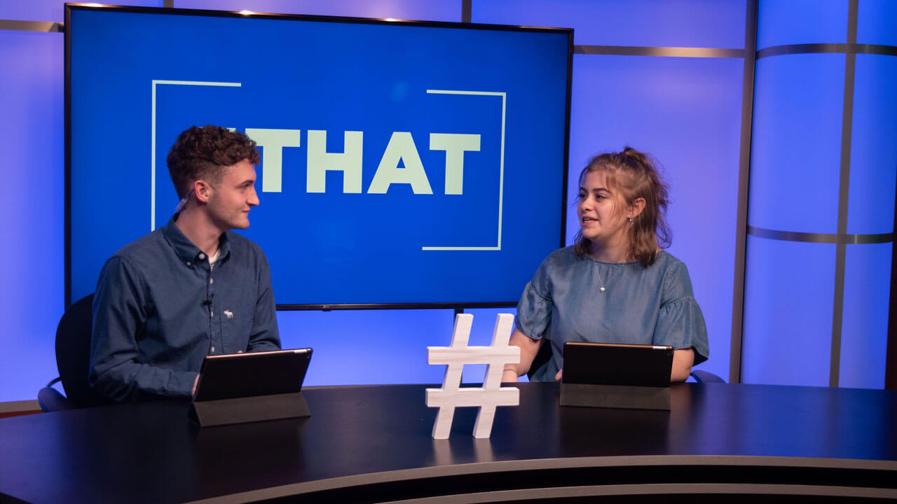 Joe LoGrippo and Abby Blackmore live on hashtag that on the desk at the new Q30TV set