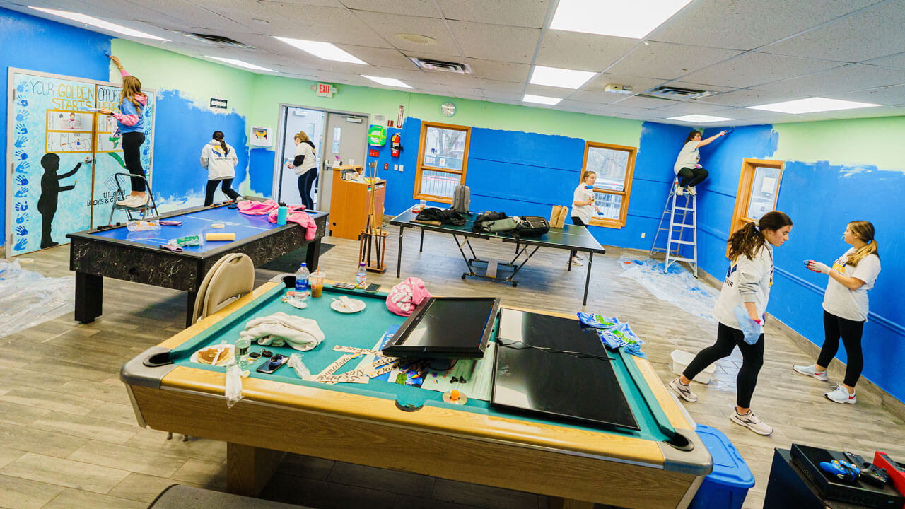 Group of students painting a classroom during the Big Event