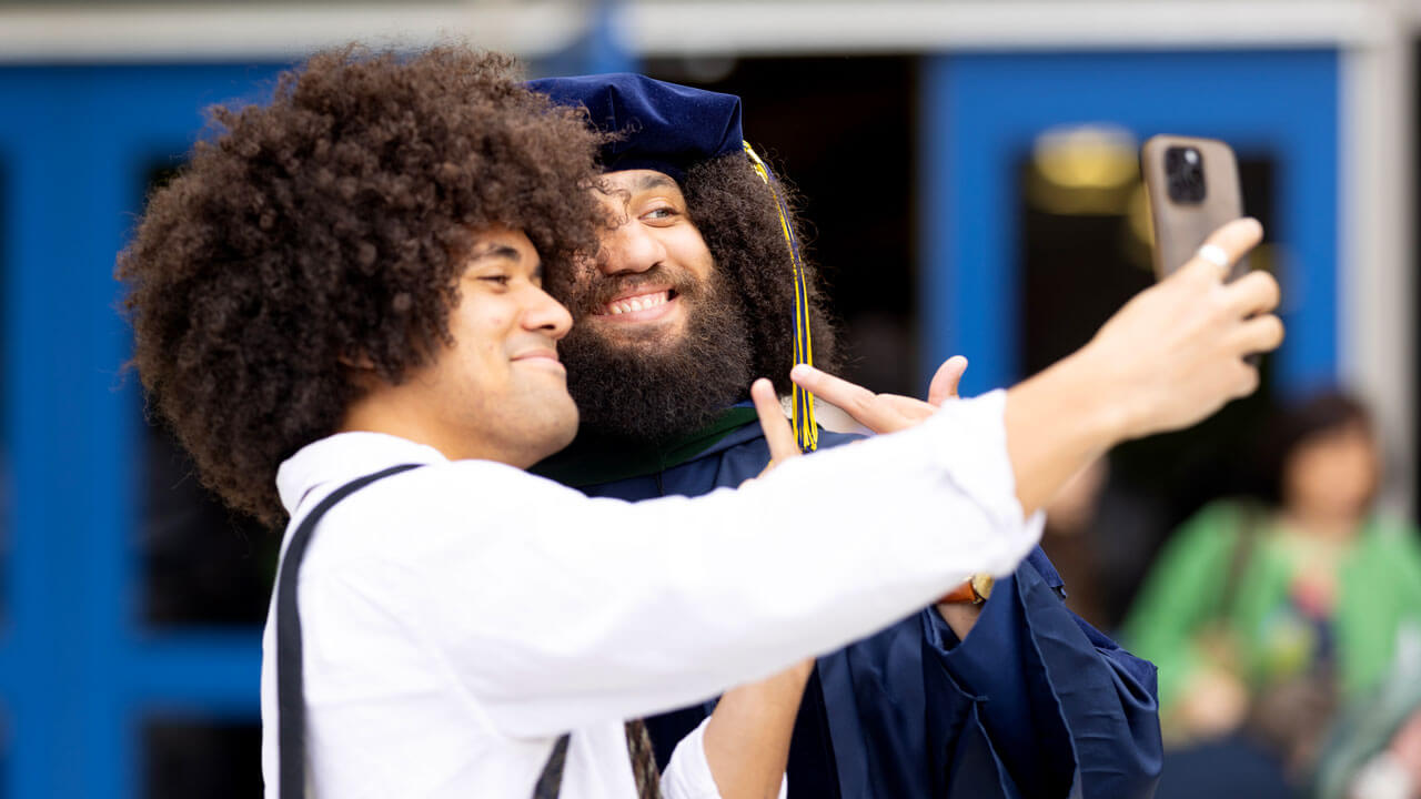 School of Medicine graduate takes selfie with a friend