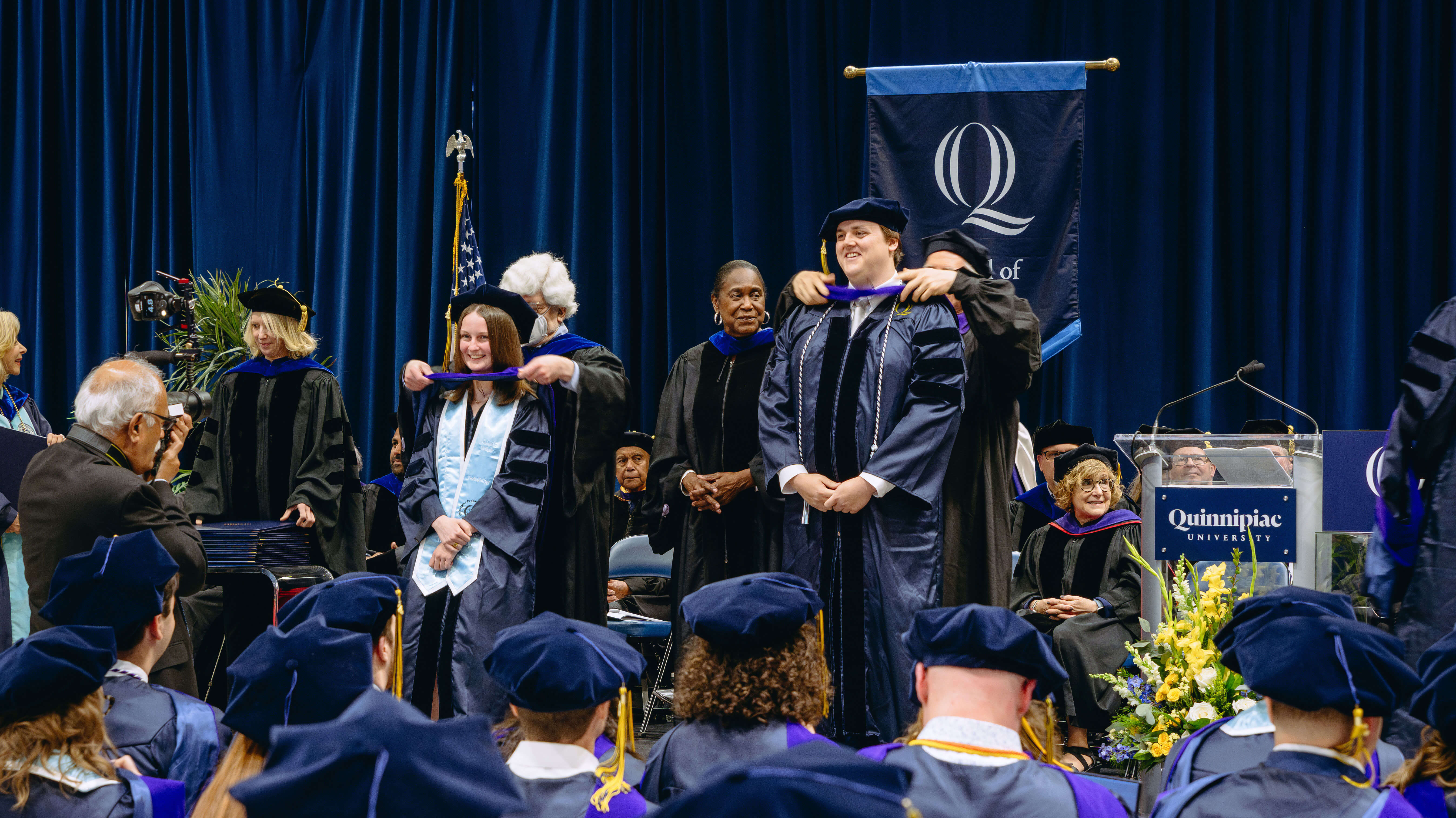 School of Law graduates standing on the stage at commencement