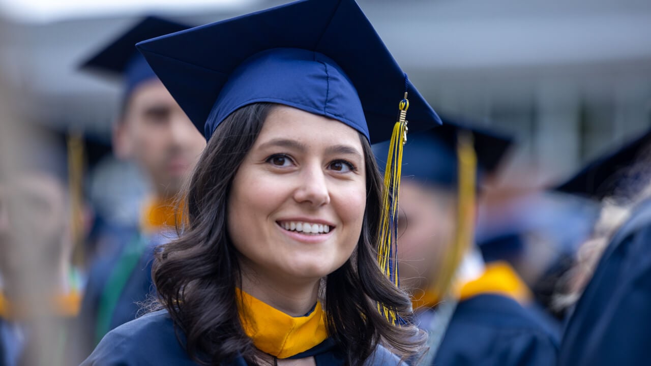A close up photo of a smiling graduate