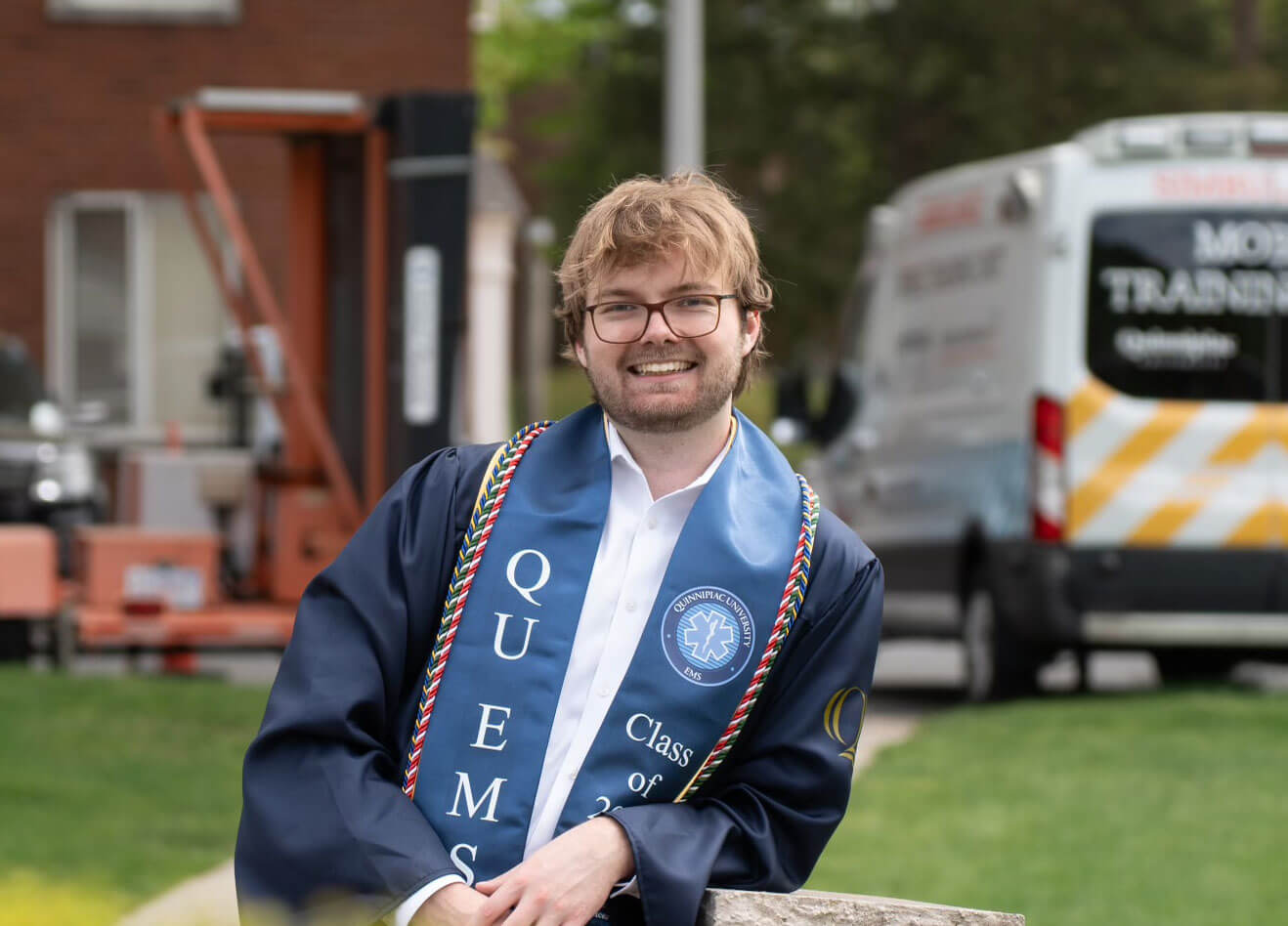 Jonas Vorbau smiling in his graduation gown