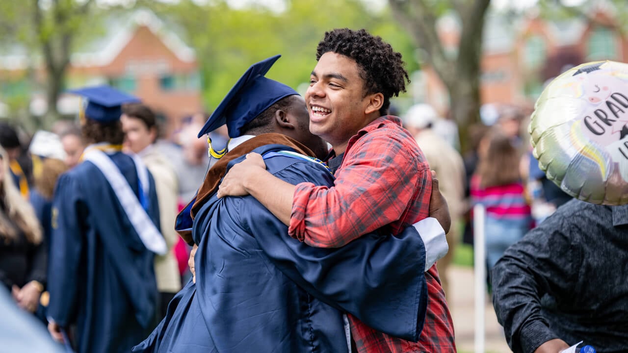 A graduate hugs a guest