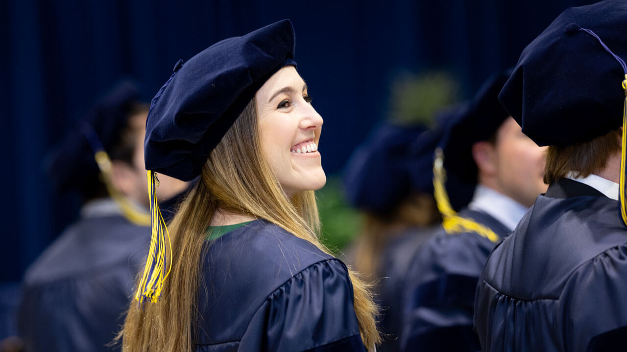School of Medicine student smiling in her cap and gown