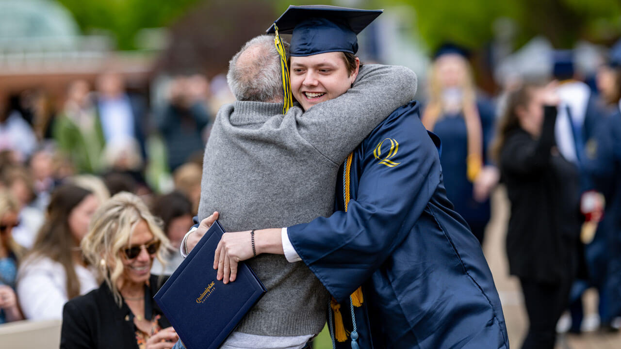 SOC graduate hugging their family member after ceremony