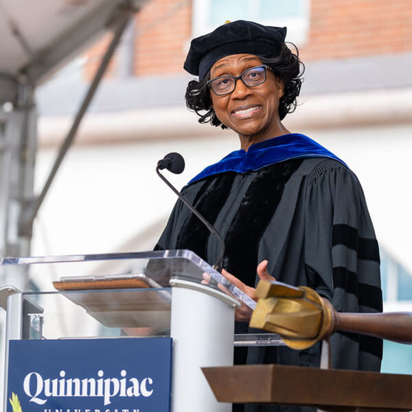 Charlene Russell-Tucker speaks at a podium during Quinnipiac Commencement