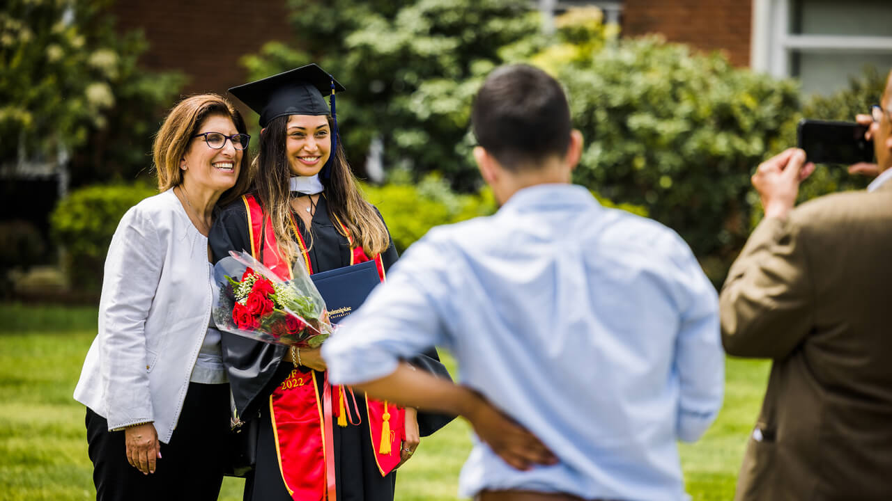 A graduate takes photos with her family