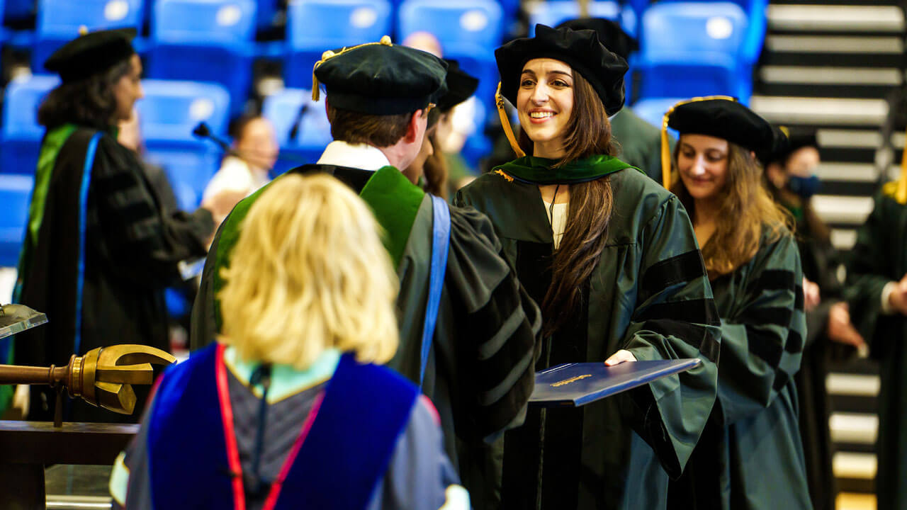 A graduate medical student receives her diploma