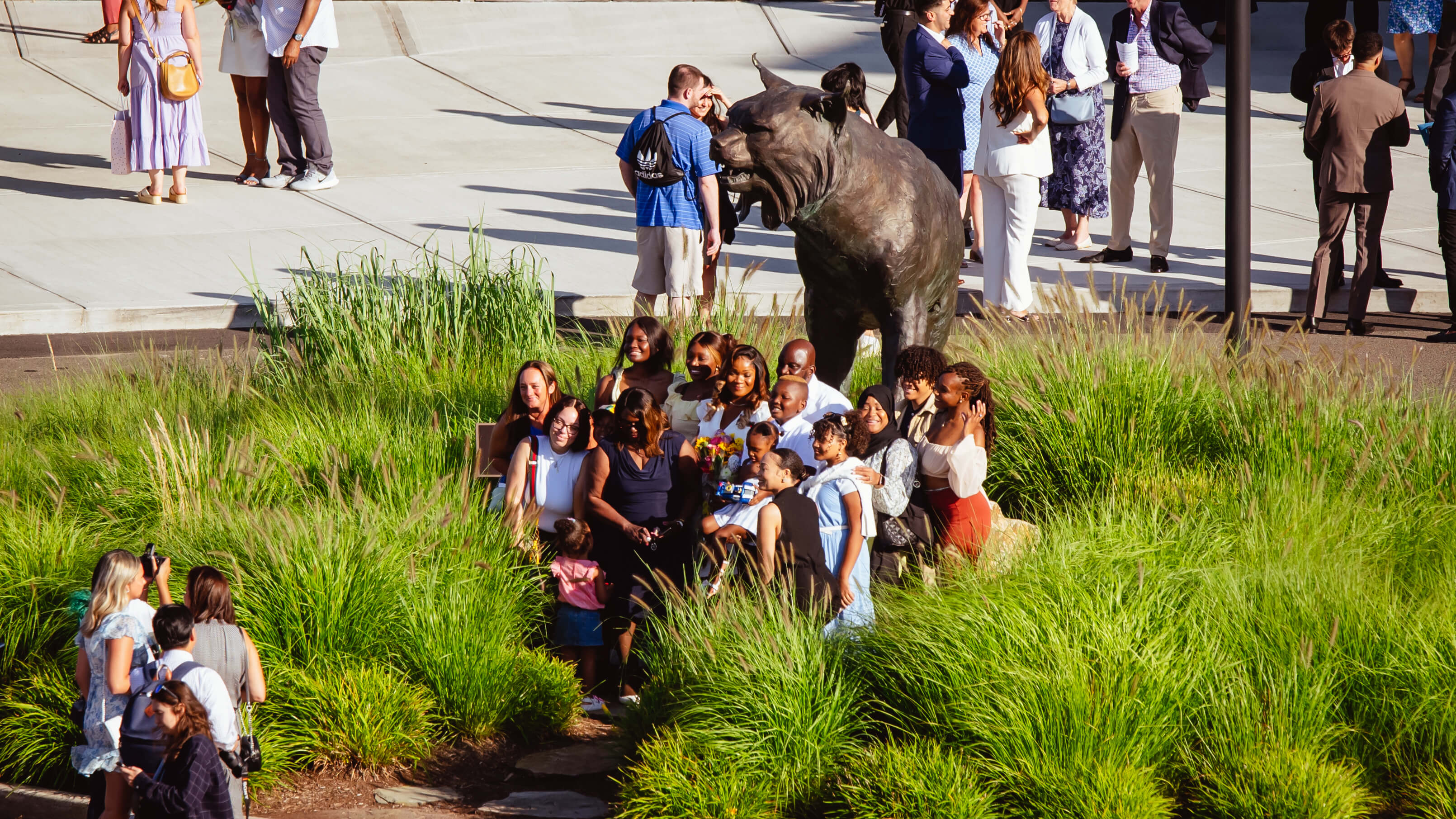 Family and friends take a photo in front of the Bobcat statue on Rocky Top
