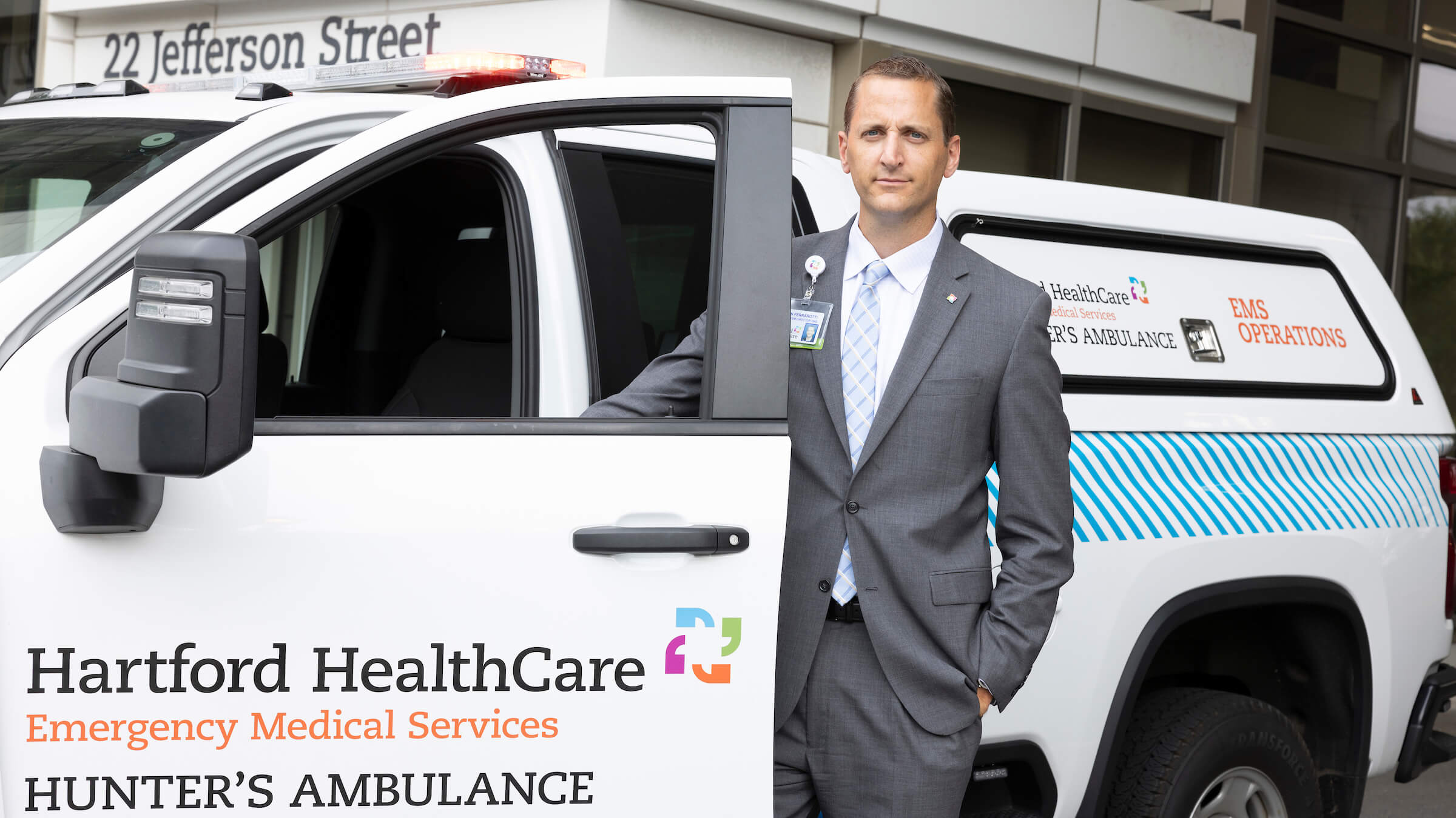 Kevin Ferrarotti stands next to an ambulance