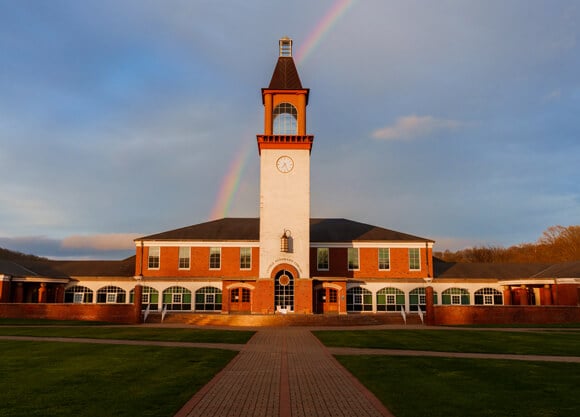 Rainbow behind the library clocktower on an autumn day
