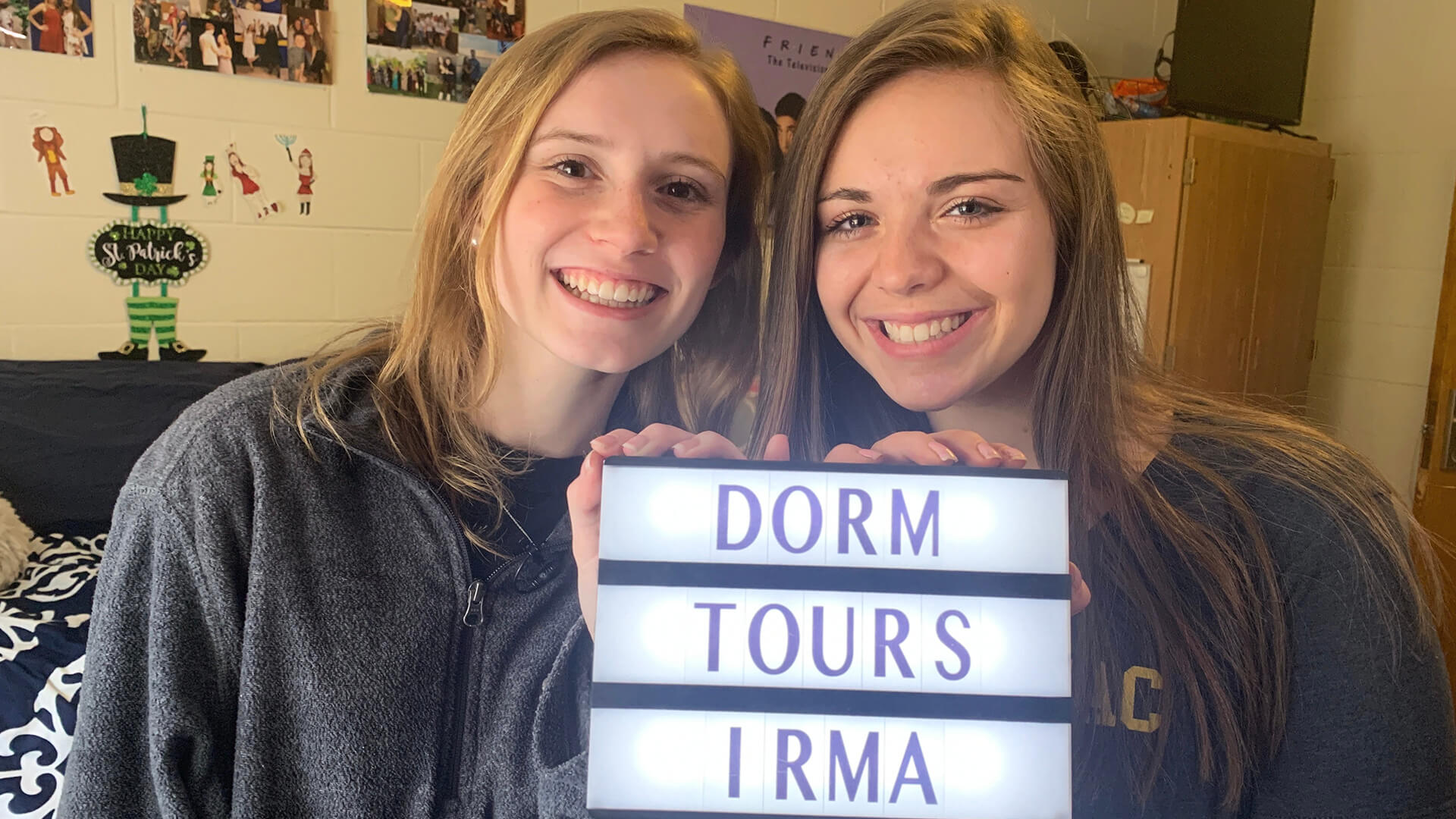 Suzette holding an Irma sign with her roommate