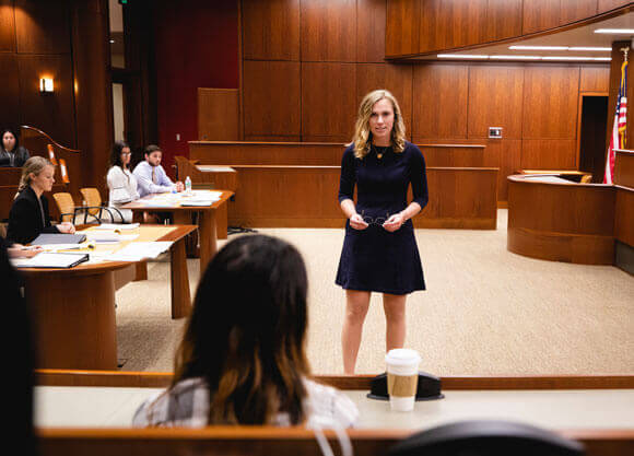 Quinnipiac student participates in a mock law trial at the School of Law Courthouse on the North Haven Campus.