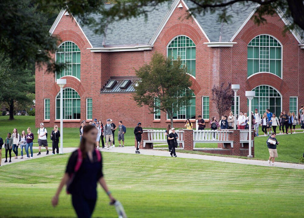 Dozens of students walk across the quad on the Mount Carmel Campus