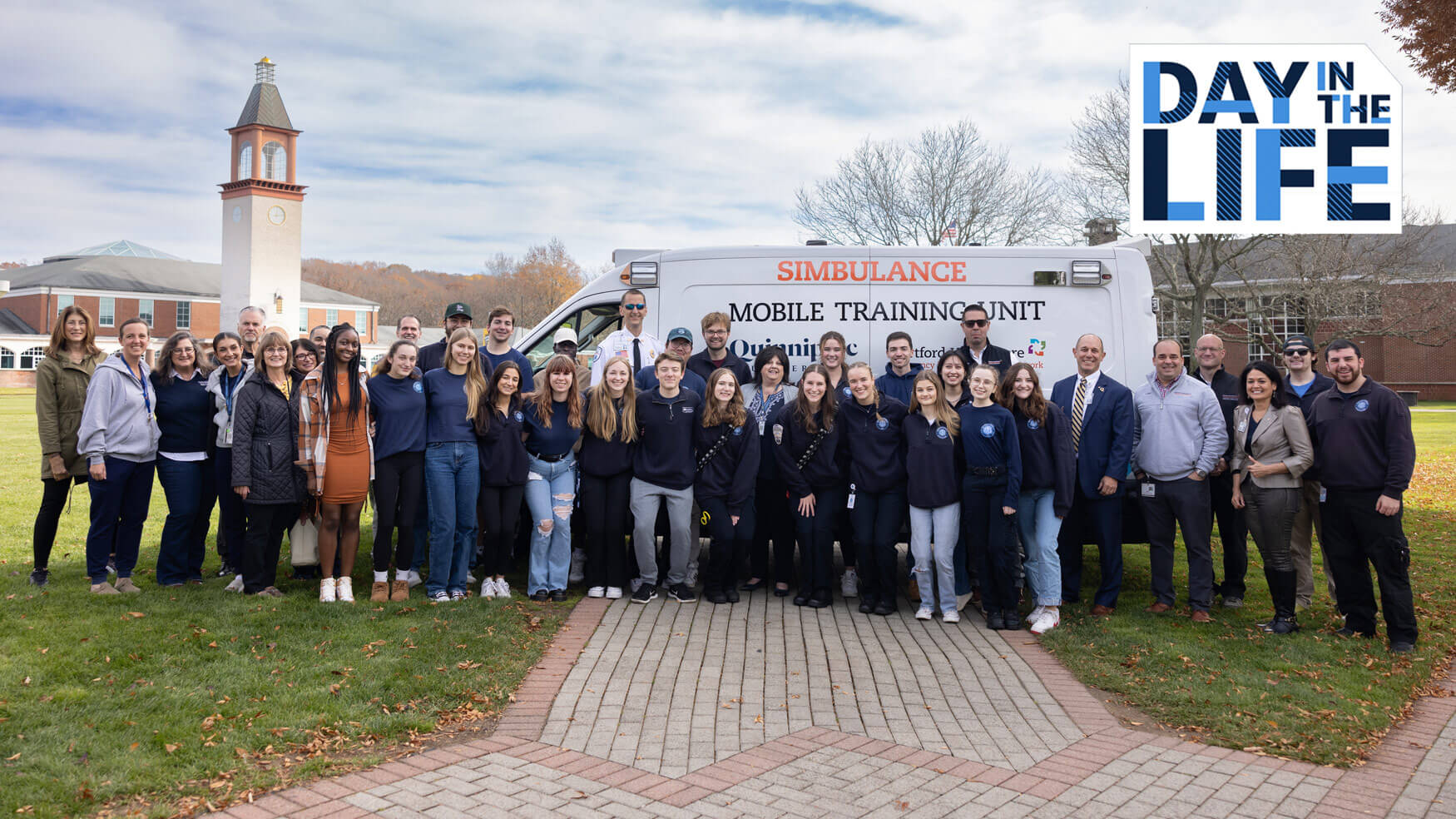 Entry level master's physician assistant students pose with an ambulance simulator.