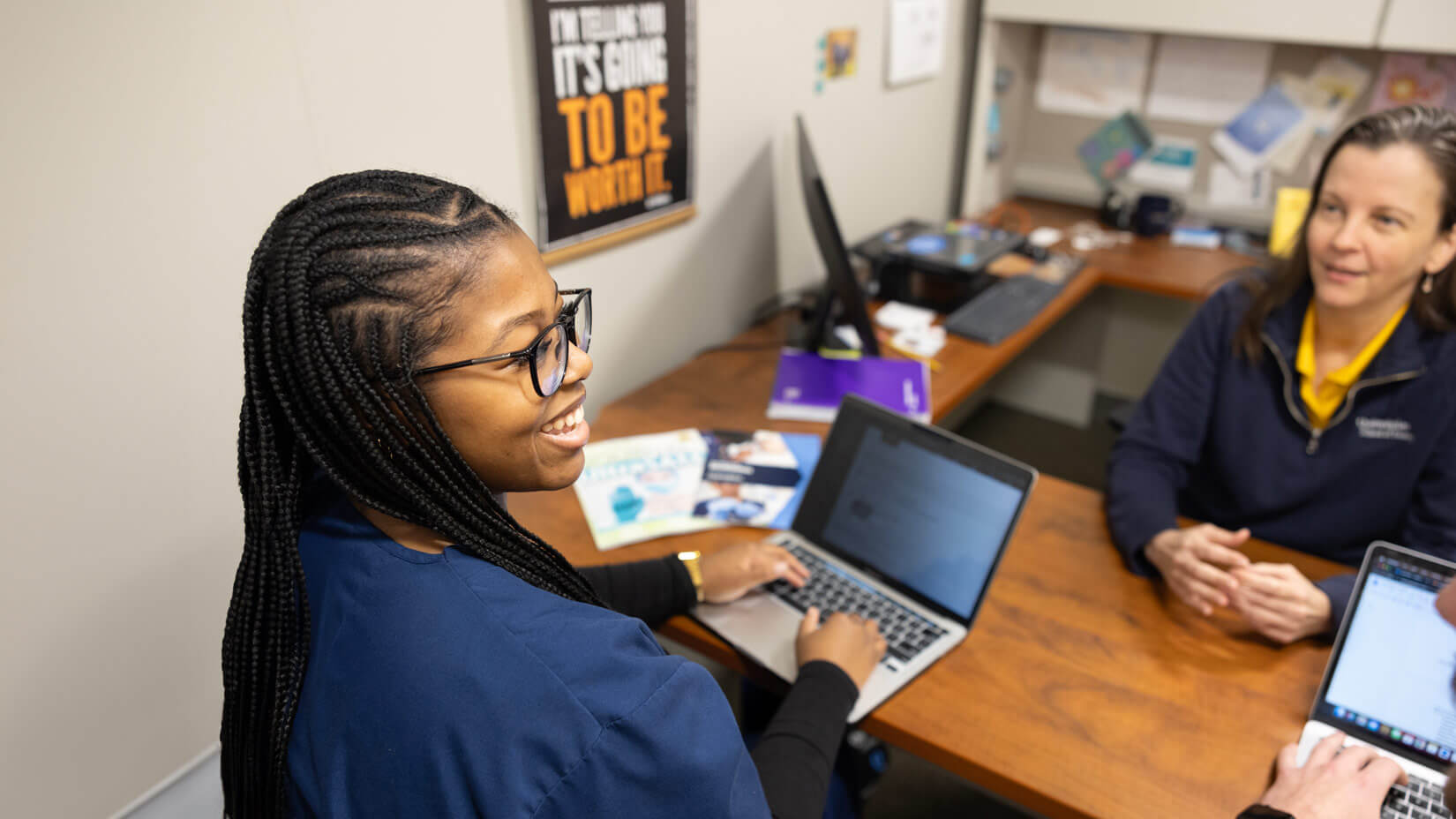 A School of Nursing student smiles during an academic advising session.