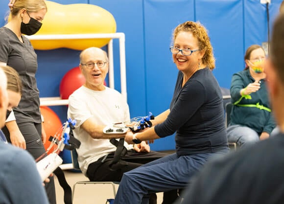 StrokeOT founder Carolyn Brown works with stroke survivors in the Quinnipiac University Movement Lab