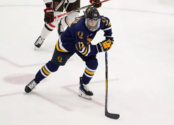 A Quinnipiac women's ice hockey player skates across the ice