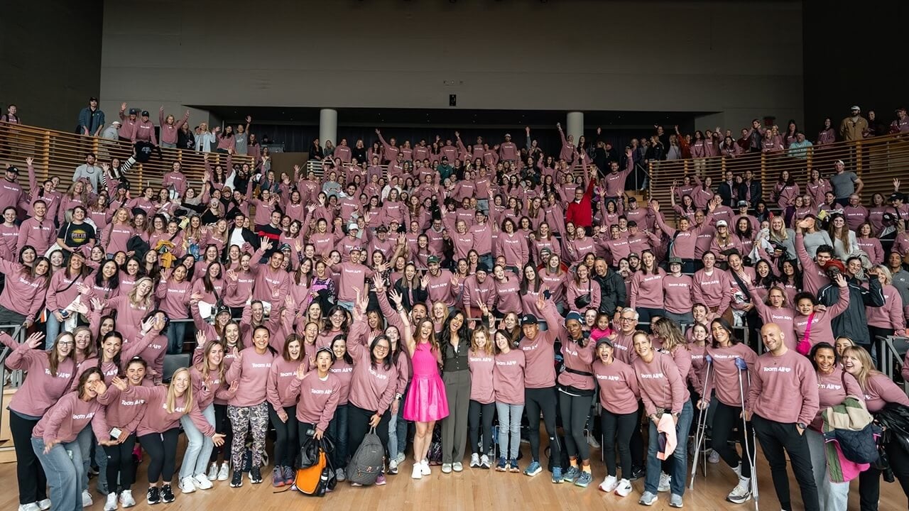 Alison Feller smiles with supportive crowd behind her