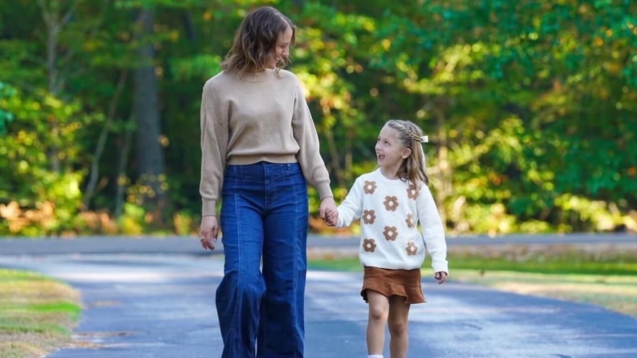 Alison Feller holds hands with her daughter