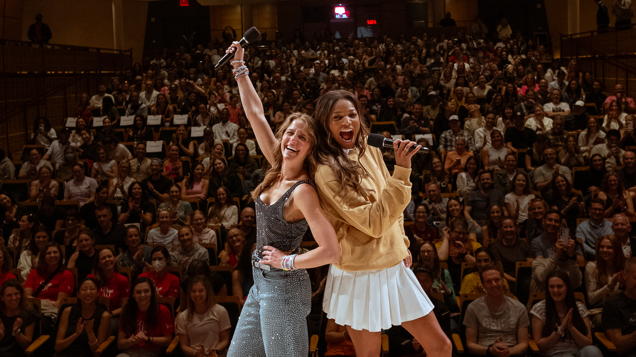 Alison Feller holds microphone in front of crowd