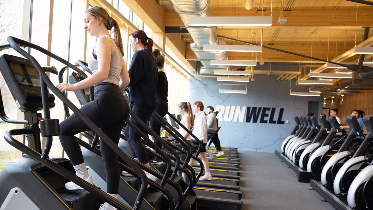 Students exercise on treadmills and stair climbers
