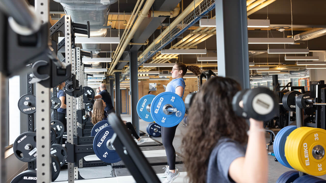 Students lift weights and use weight lifting machines