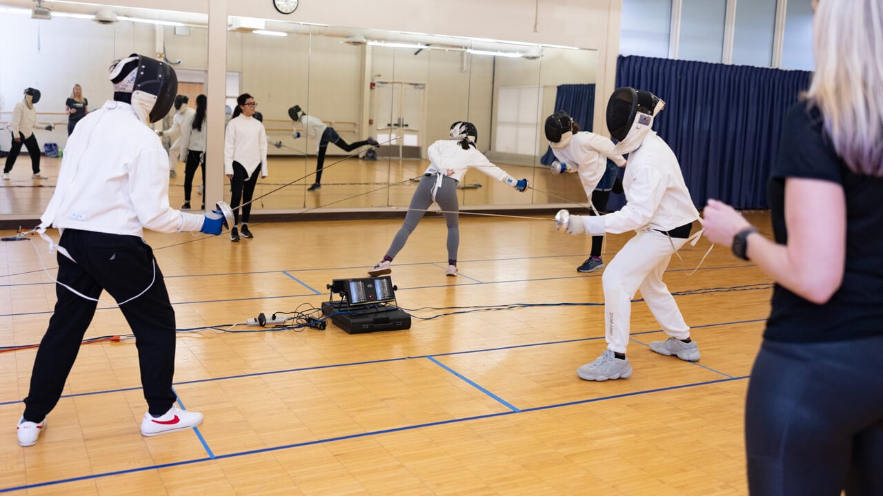 Students participate in a fencing class
