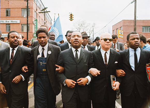Dr. Martin Luther King Jr. participates in a civil rights march.