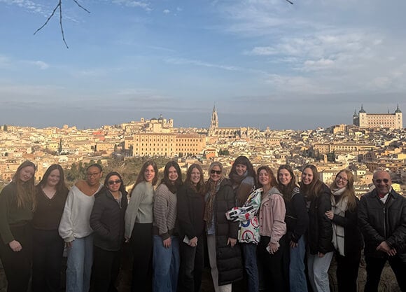 Group of students and faculty standing outside the city walls of Toledo, Spain