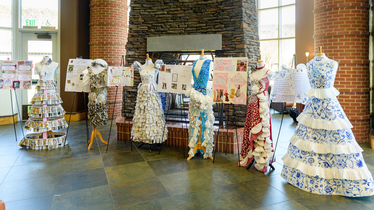 Dresses composed of recycled materials made by students.