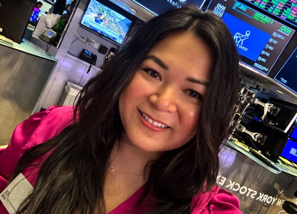 Tina Hoang smiles at the New York Stock Exchange.