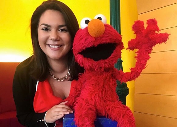 Headshot of Christina Vittas with Elmo at Sesame Workshop
