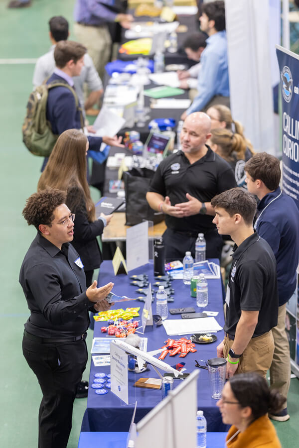 Students speaking to employers at a career fair