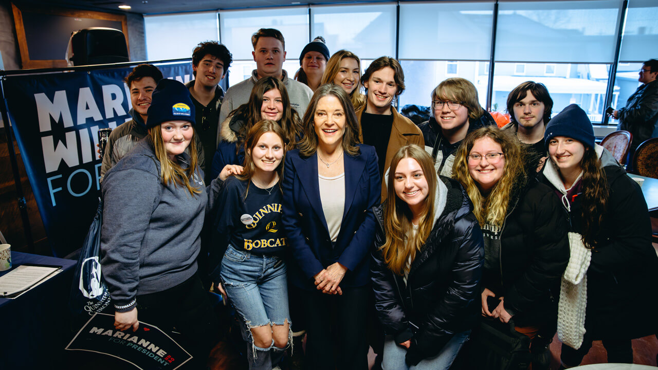 QU students with candidate Marianne Williamson