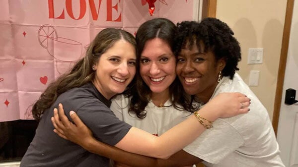 Quinnipiac alumna Catherine Campbell poses with friends for a picture