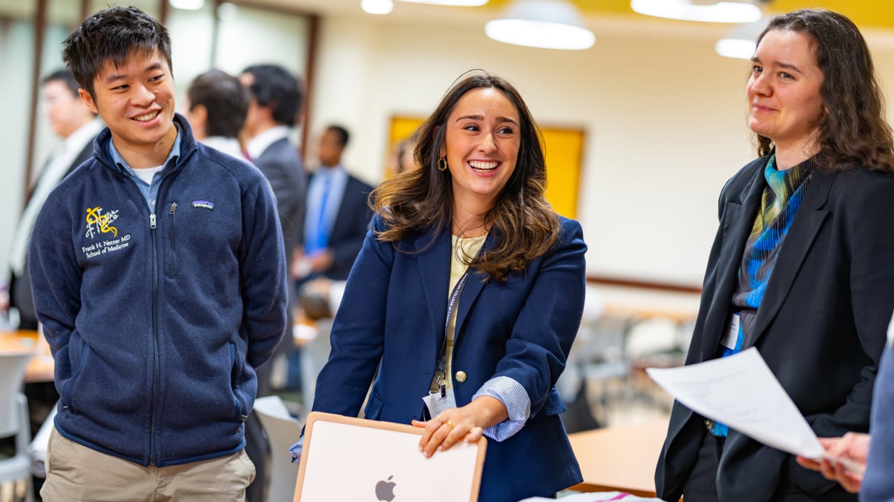 Three students laugh.