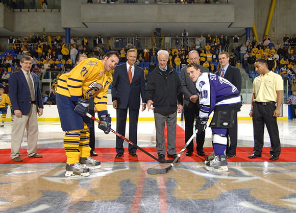 Gordie Howe participates in puck drop, opening the sports arena.