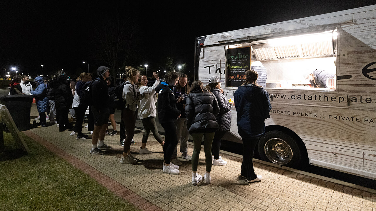 Students line up at food truck during rec and wellness opening.  duri