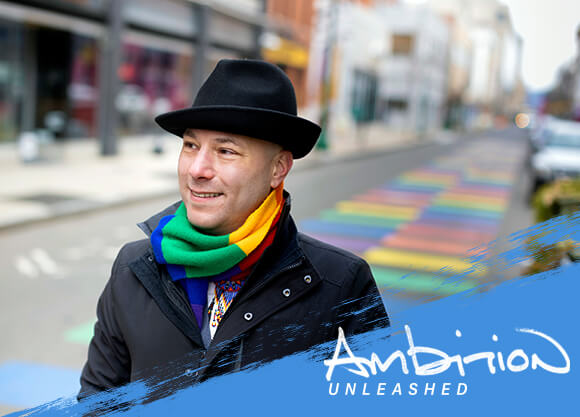Ambition Unleashed: Vince Contrucci walks across a street with a rainbow crosswalk in New Haven