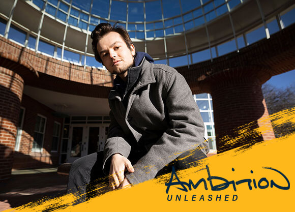 Ambition Unleashed: Jack Ebert sits outside the Lender School of Business Center