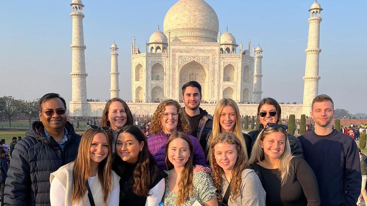 MBA students stand in front of the Taj Mahal in India.