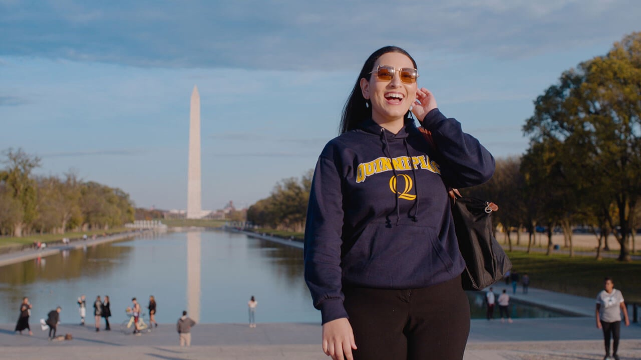 Ambar Pagan in front of the reflecting pool and Washington Monument