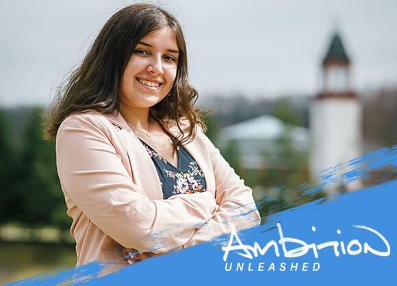 Ambition Unleashed: Jen McCue in front of the Arnold Bernhard Library at Quinnipiac