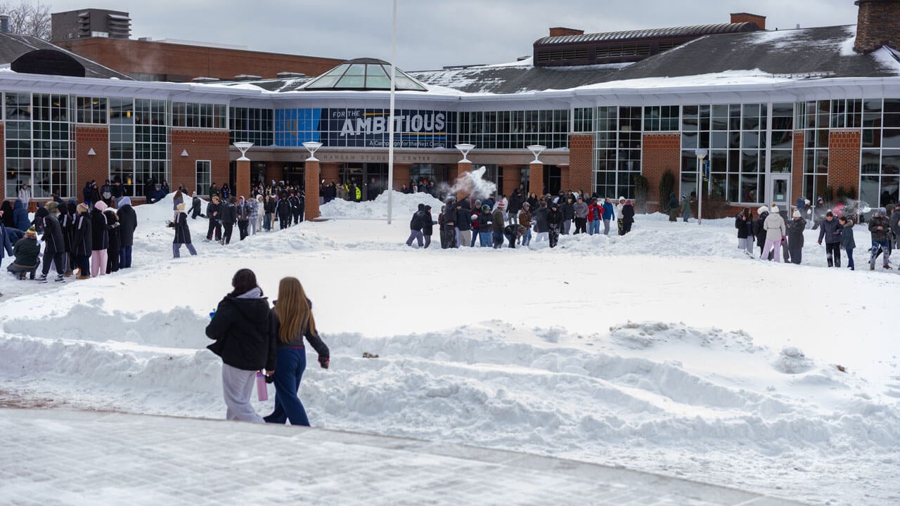 Students play in the snow
