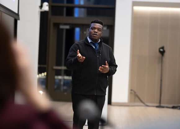 Student presenting to an audience in an auditorium