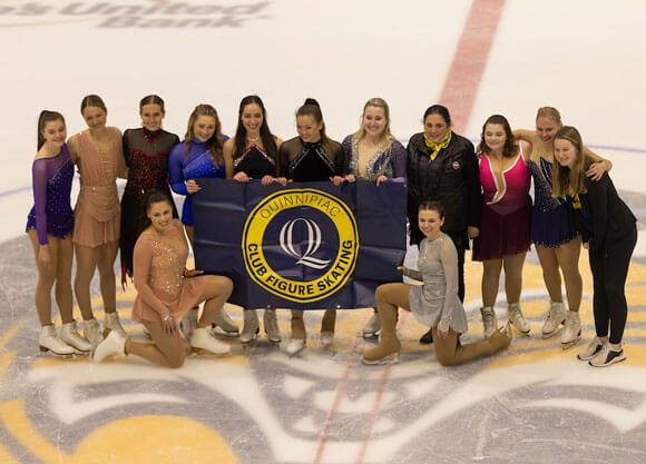 Figure Skating group posing with club banner