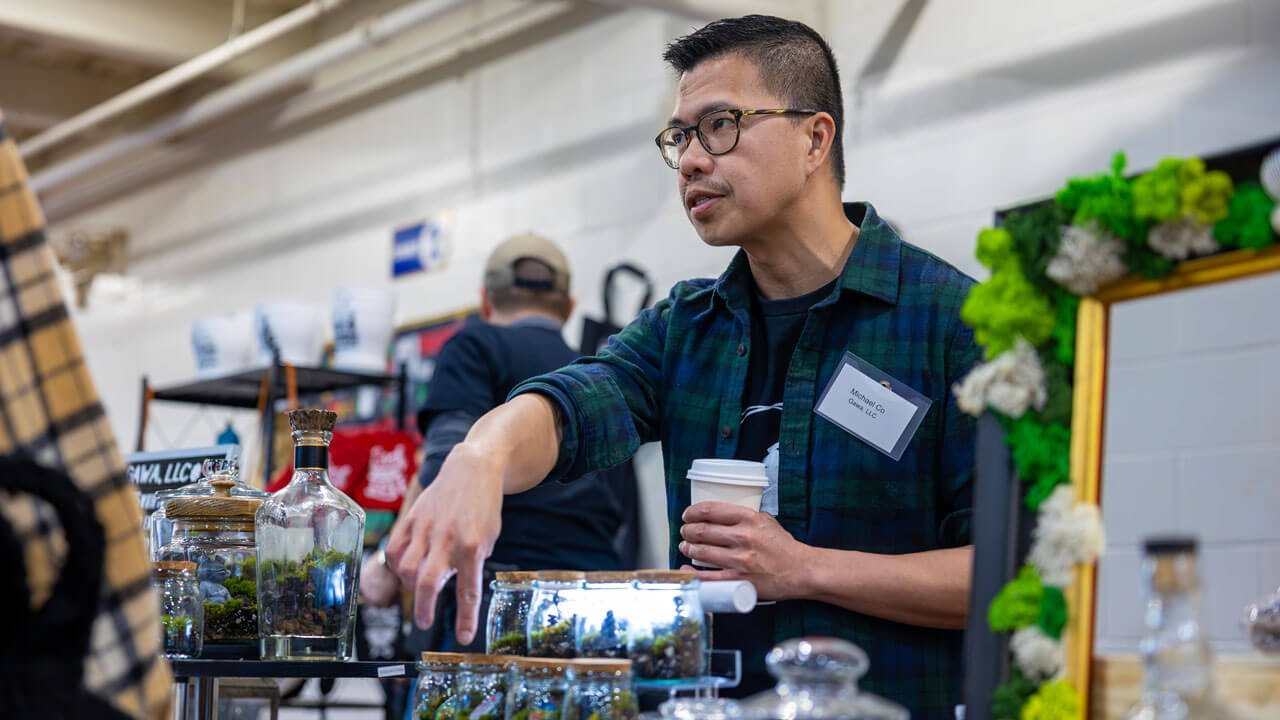 A vendor explains their plant product to a customer.